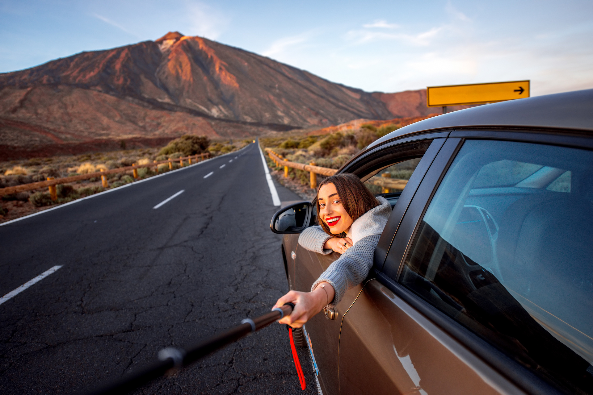 Woman in car with volcano on background All About Tenerife Things To Do In Tenerife Most Popular Attractions In Tenerife